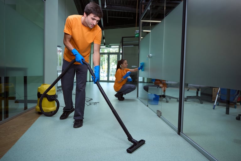 Professional cleaner vacuuming floor